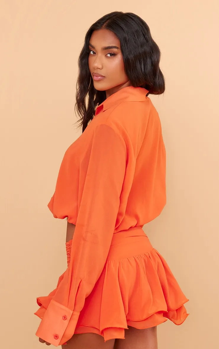 Chemise manches longues orange en mousseline de soie à taille élastiquée